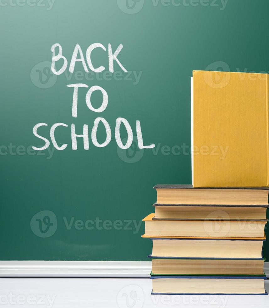 green chalk school board and stack of books photo