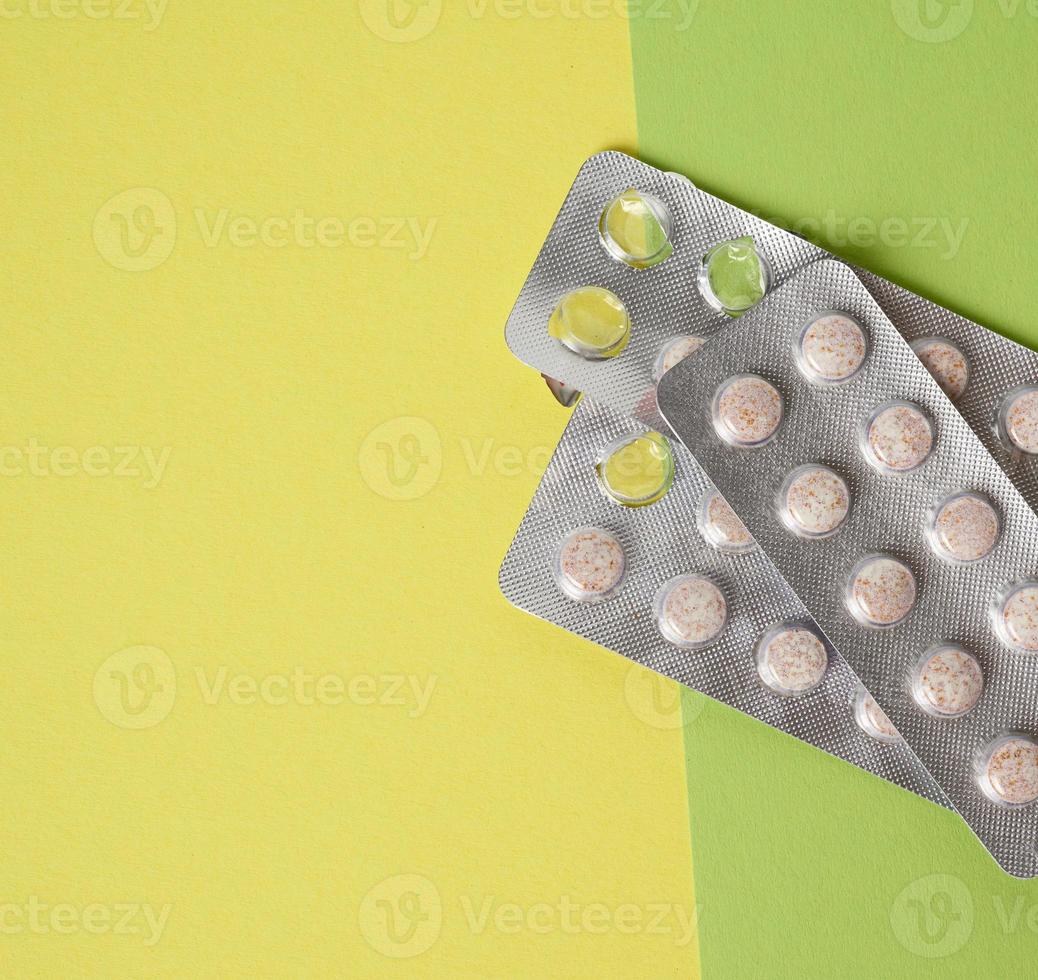 blister packaging with round pills on green background photo