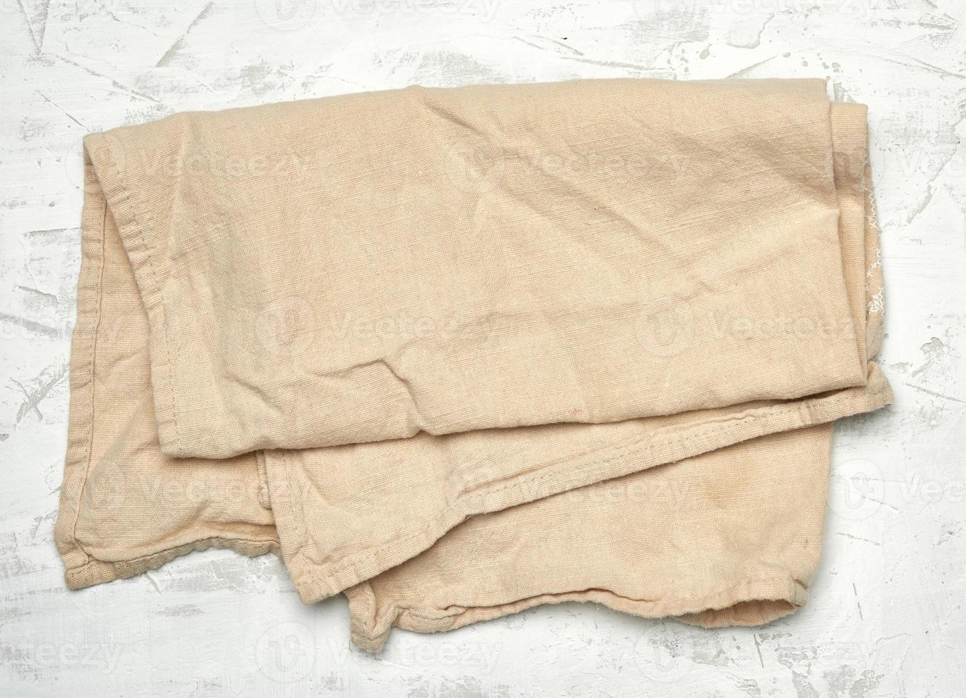 https://static.vecteezy.com/system/resources/previews/017/469/066/non_2x/beige-textile-kitchen-towel-on-white-background-photo.jpg