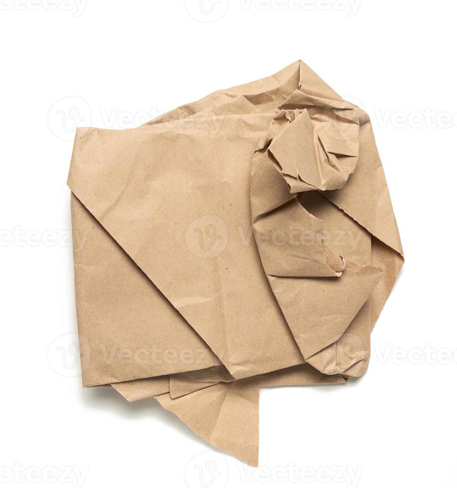 piece of crumpled brown paper isolated on white background photo