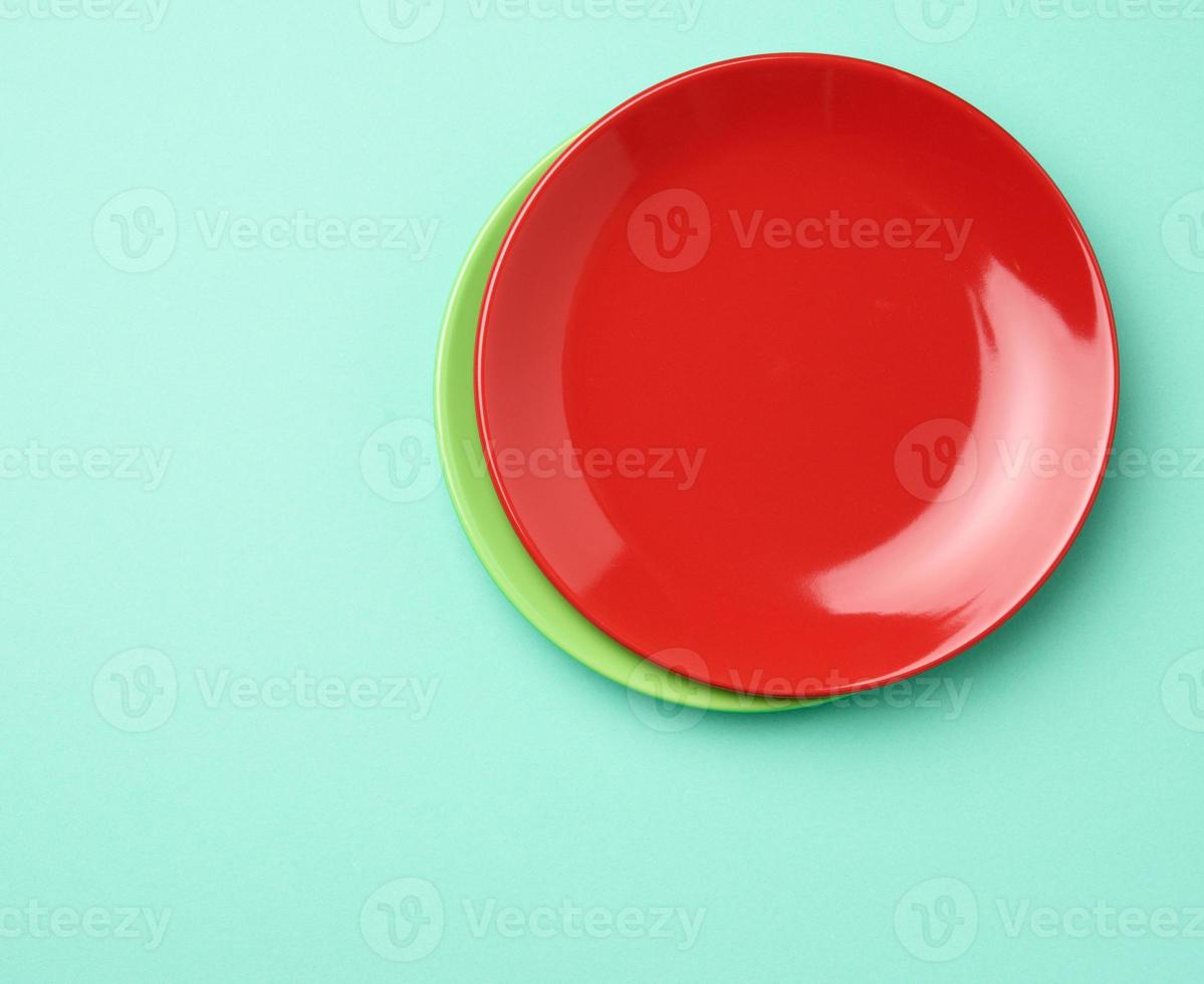 empty round red plate for main courses on a green background photo