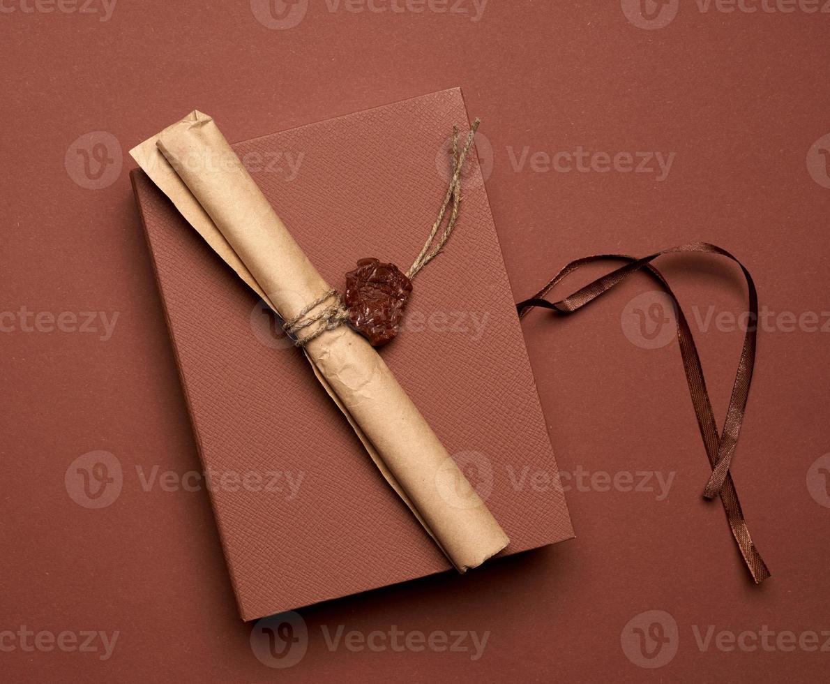 brown paper roll sealed with wax seal, top view photo