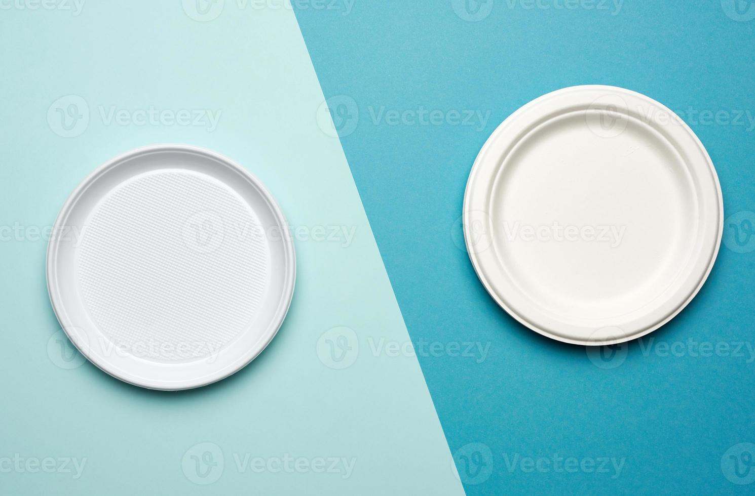 white plastic plates and white paper disposable plates on a blue background photo