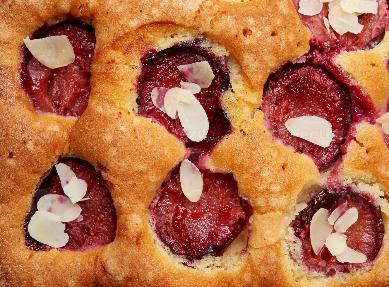 texture of baked sponge cake with plums, full frame, delicious dessert photo