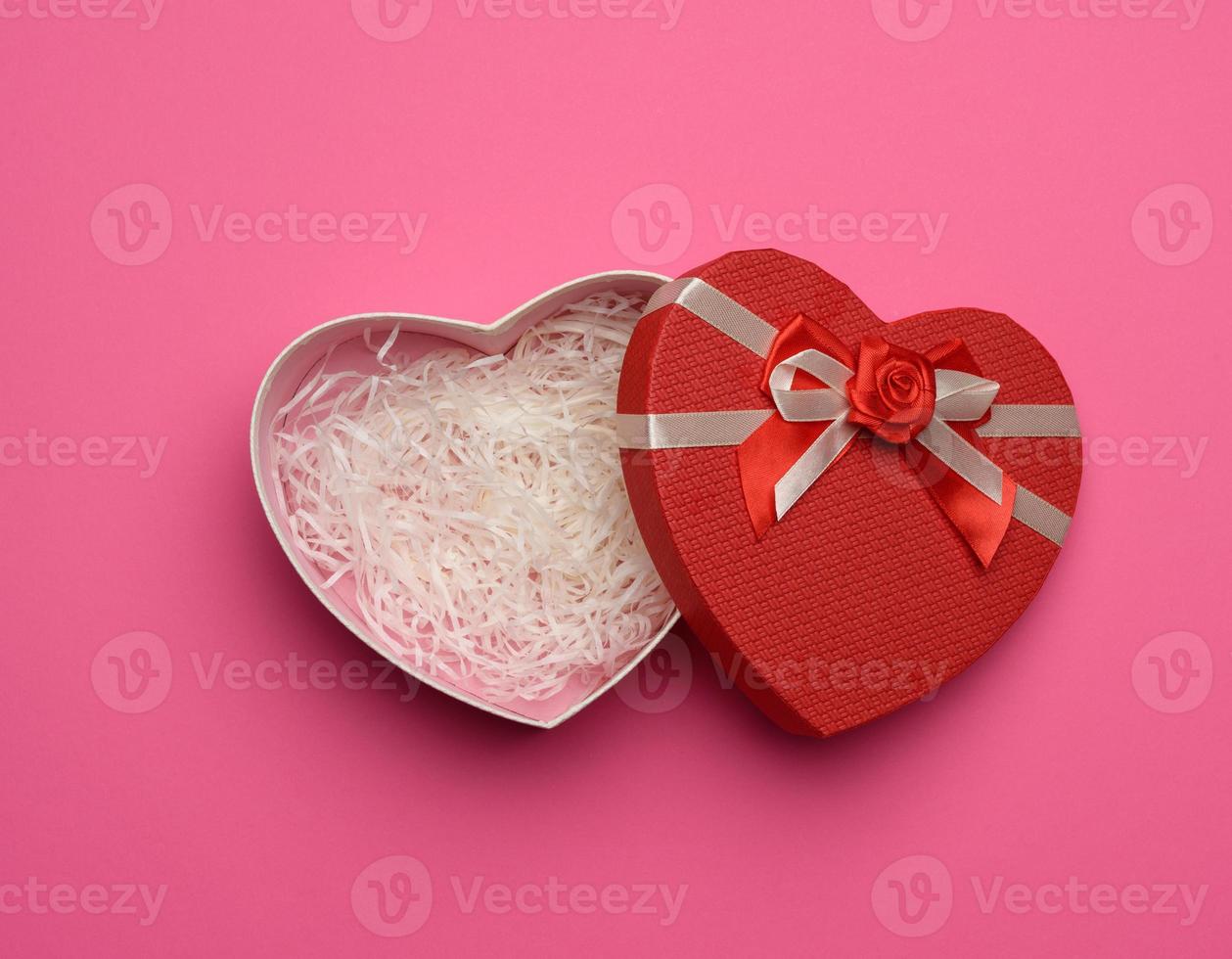 open empty red cardboard box in the form of a heart photo