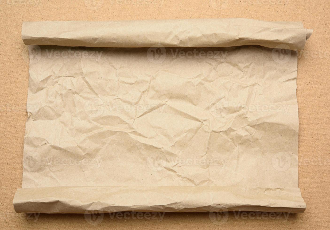 roll of brown parchment paper on a brown backgr photo