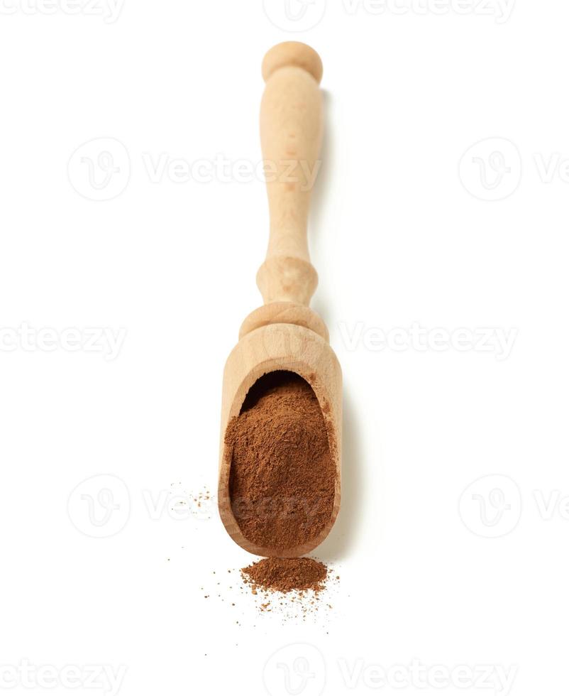 brown ground cinnamon in a wooden spoon photo