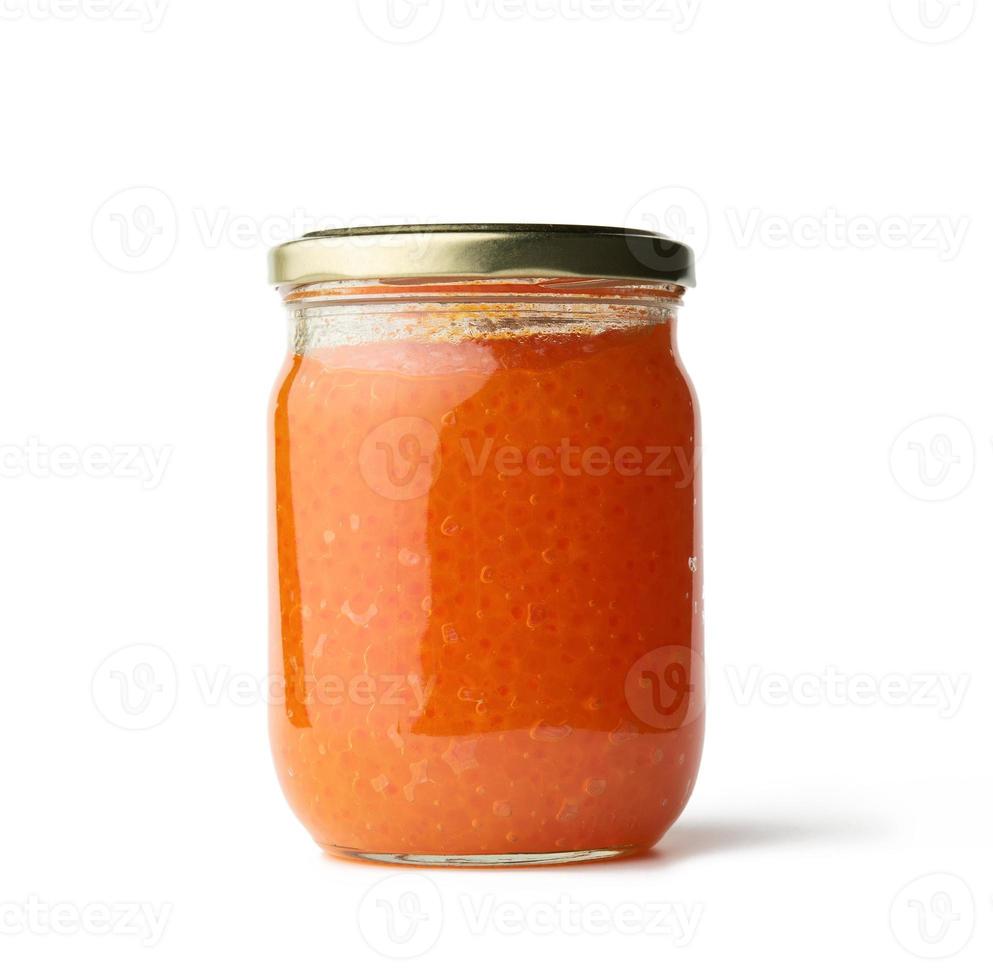 glass jar with fresh pink salmon caviar isolated on white background photo