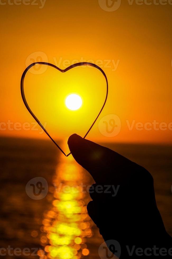 Heart shape over the sunset photo