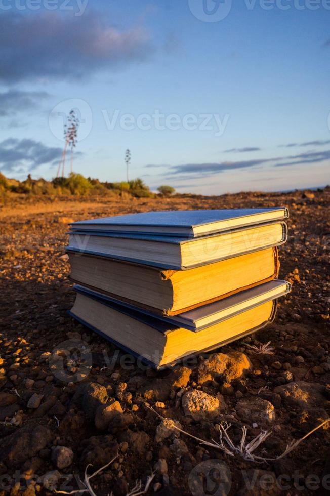 Stacked books on the ground photo