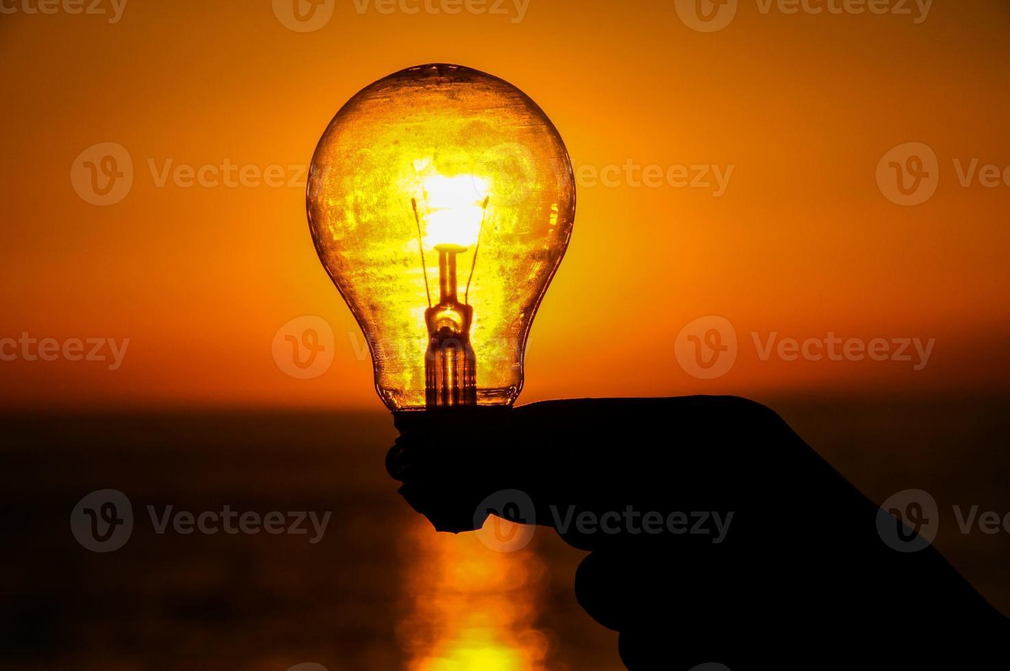 Light bulb over the sunset photo