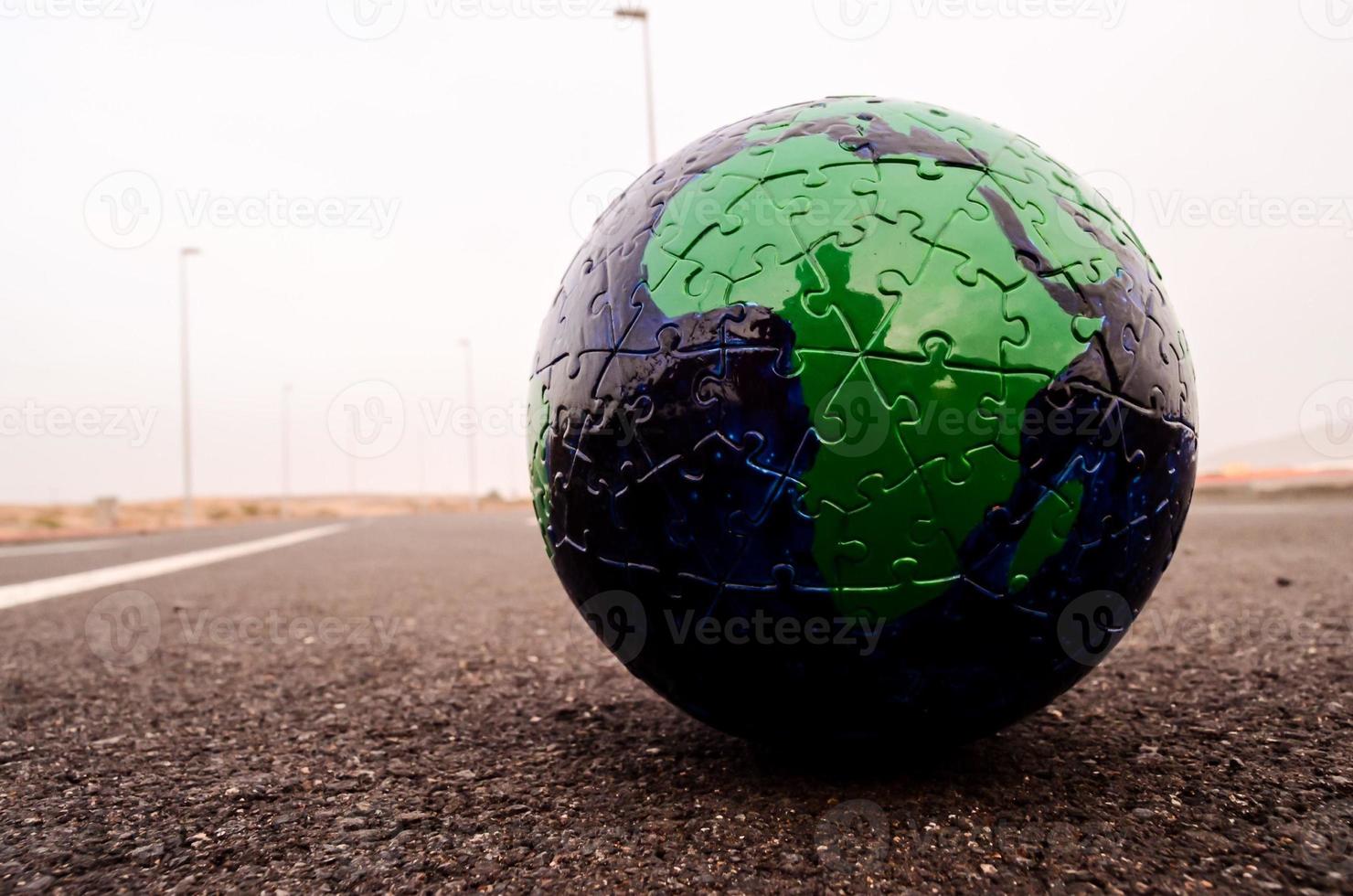 Puzzle globe on the road photo