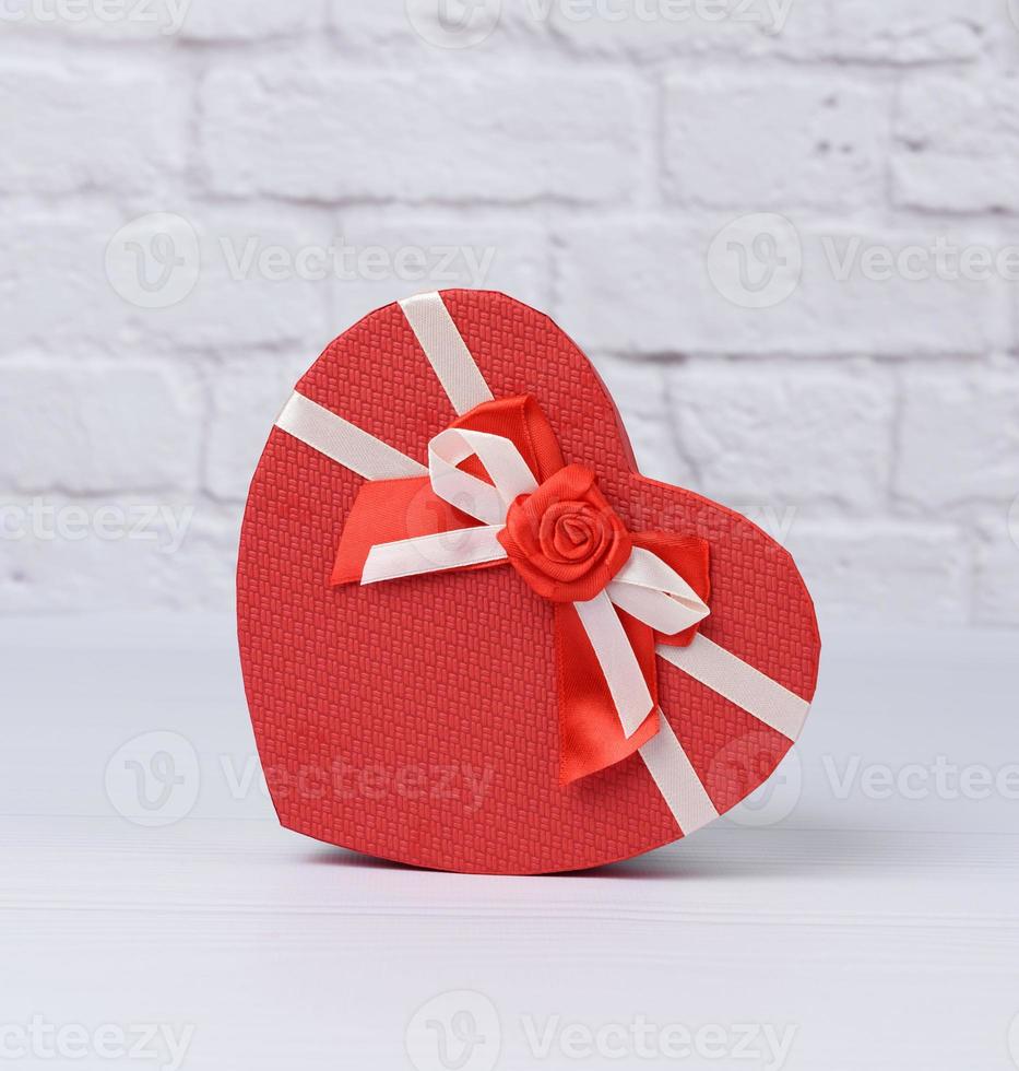 red cardboard box in the shape of a heart on a white background photo
