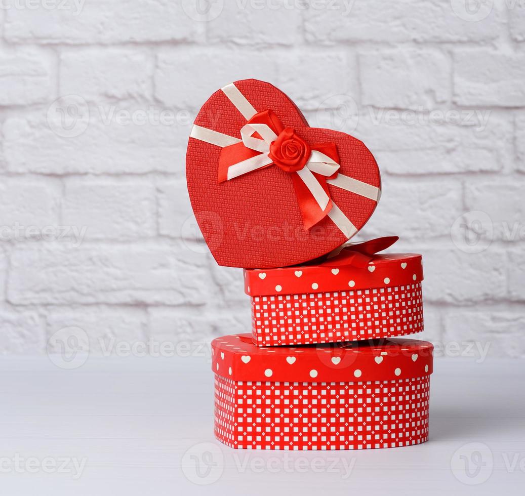 stack of various red boxes with gifts on white background photo
