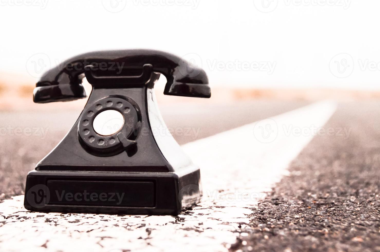 Vintage telephone on the road photo