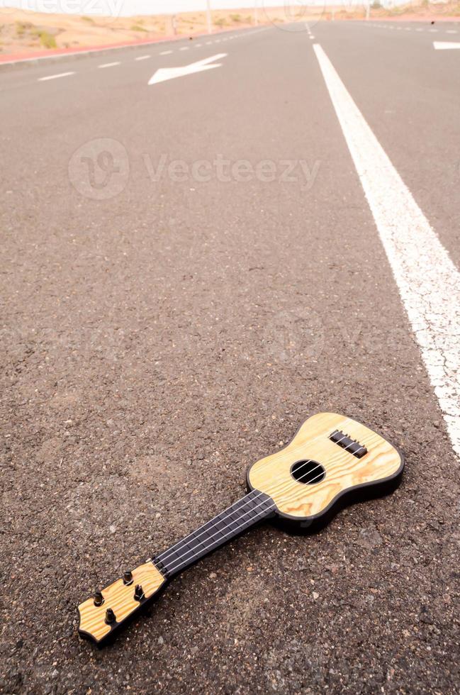 Acoustic guitar on the road photo