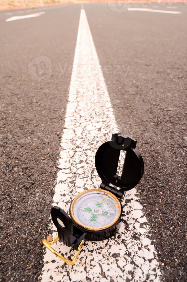 Analog compass on the ground photo