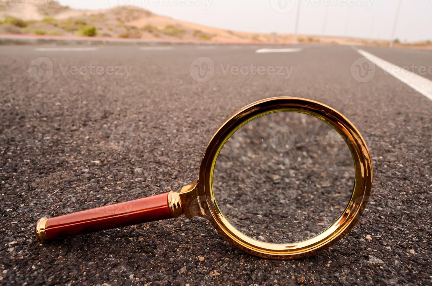 Magnifying glass on the ground photo