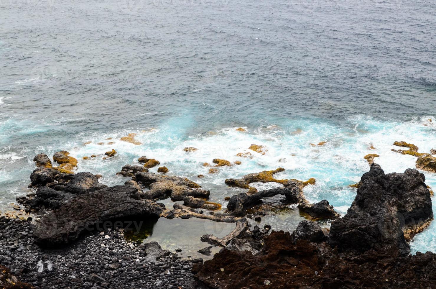 Sea waves hitting rocks photo