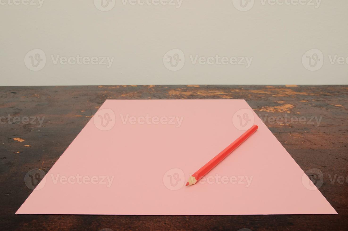 Pencil and paper on the table photo