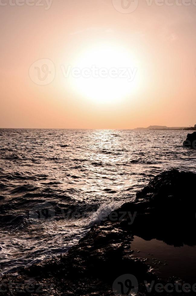 Sea waves hitting rocks photo