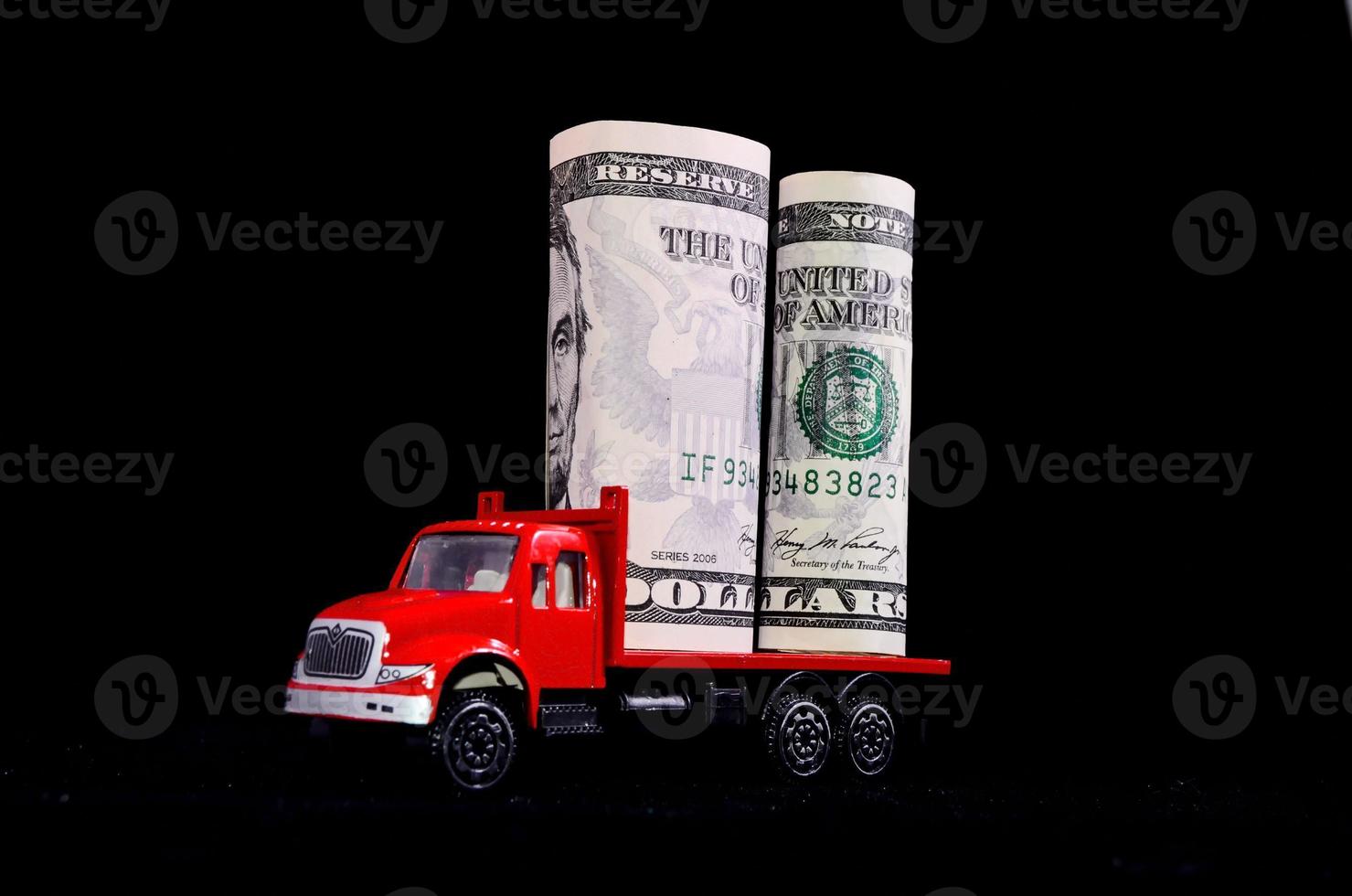 Red toy truck carrying cash photo