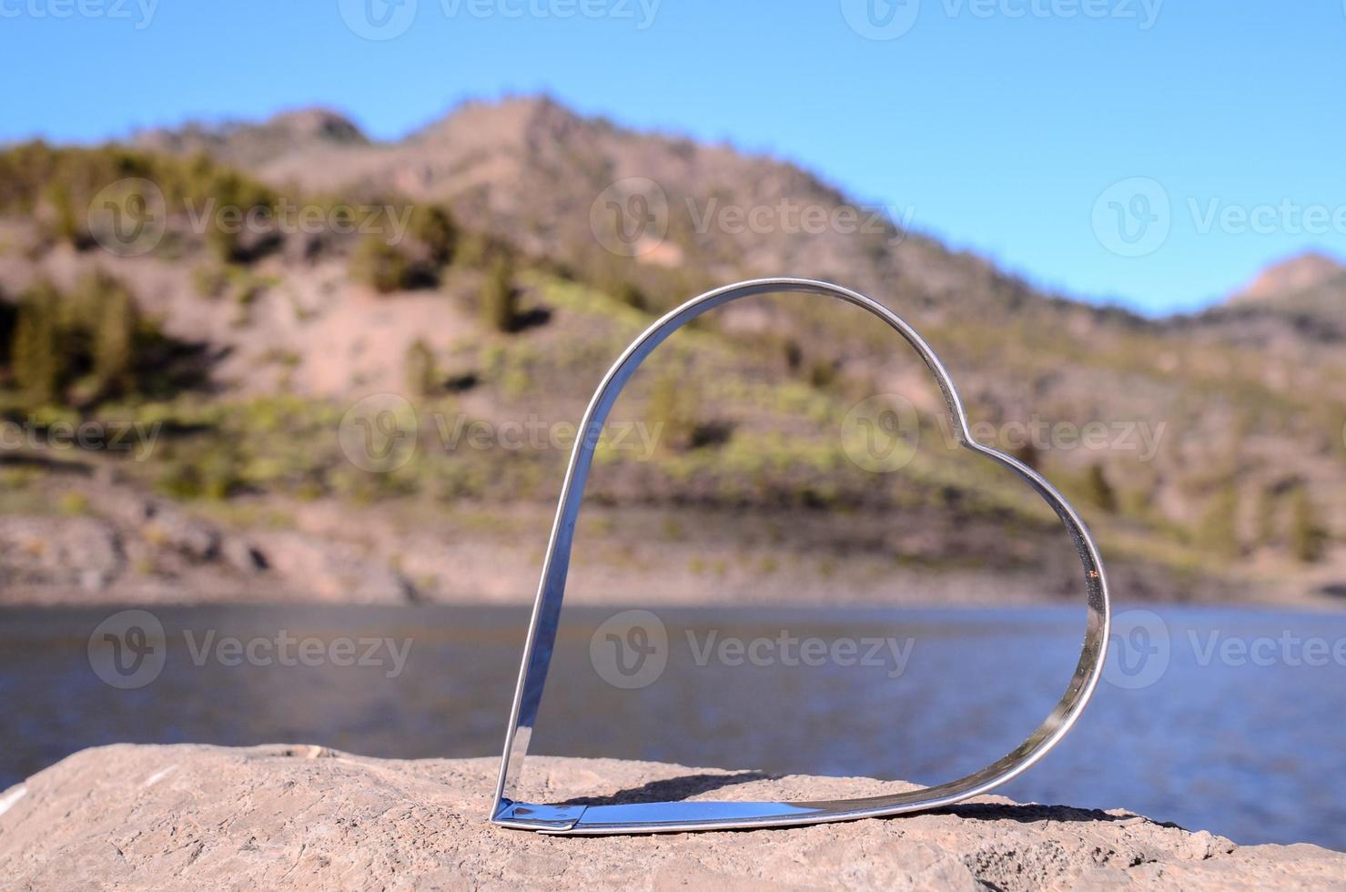 Metal heart on the rocks photo