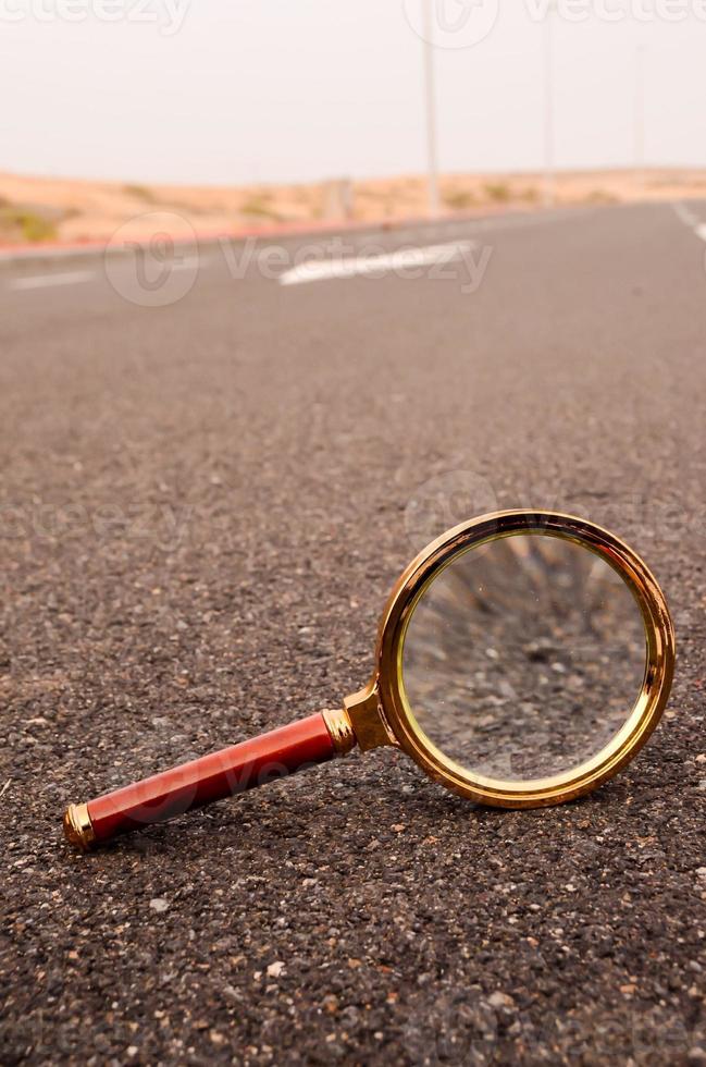 Magnifying glass on the road photo