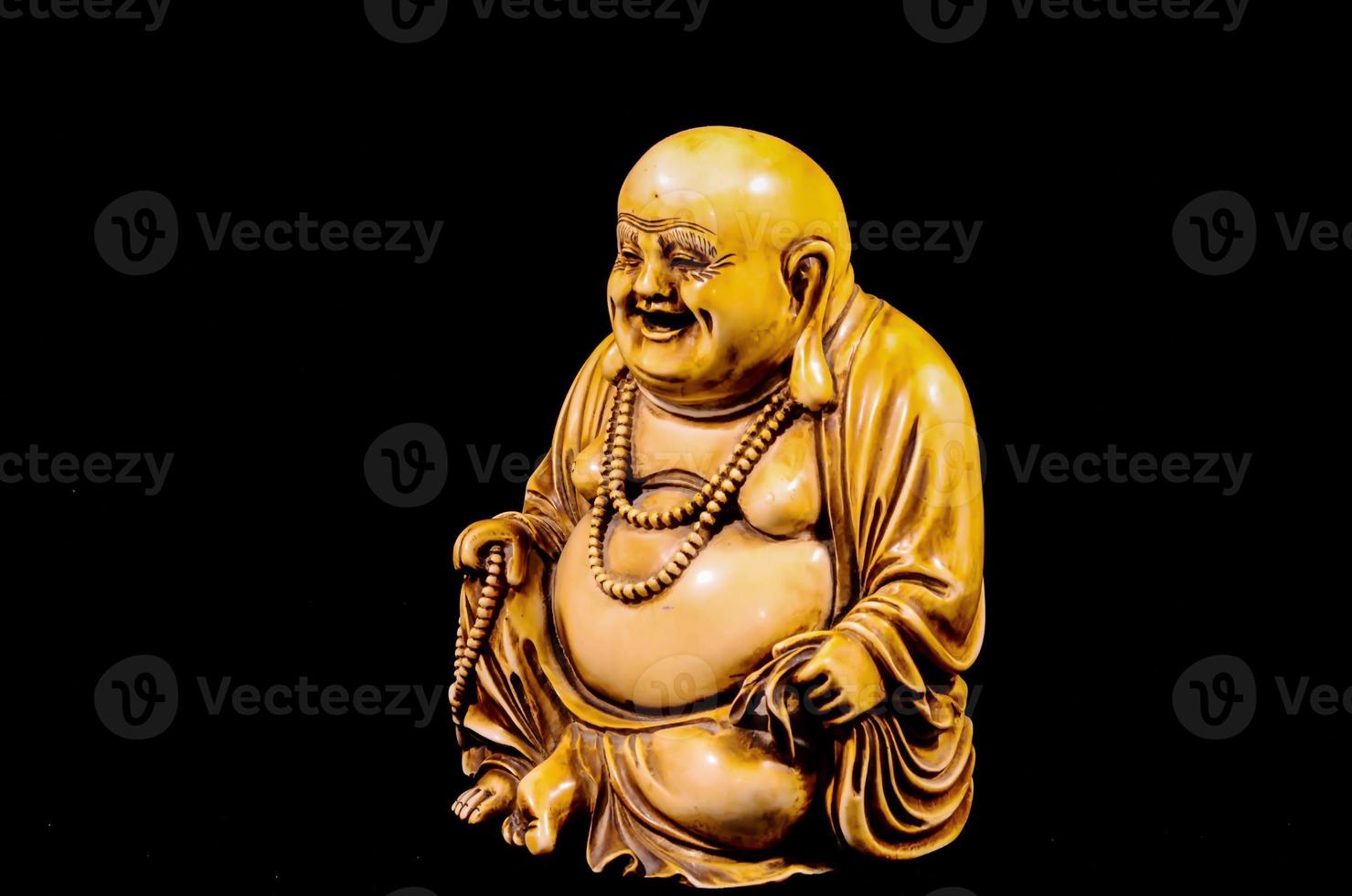 Buddha miniature on black background photo