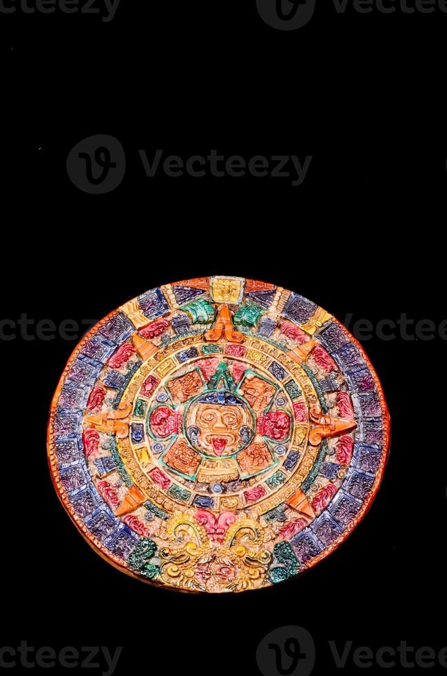 Aztec calendar on black background photo