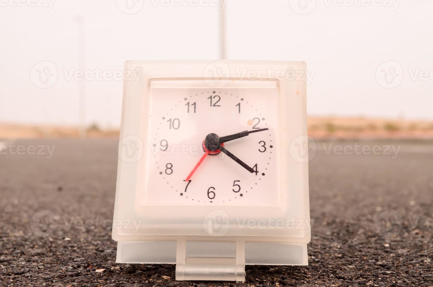 Clock on the road photo