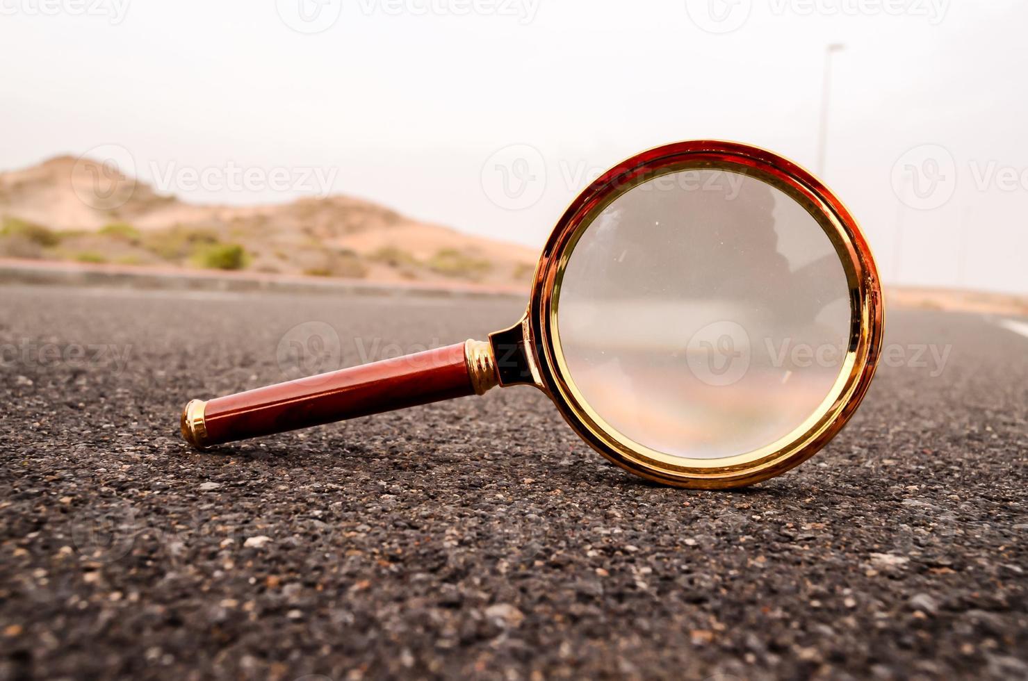Magnifying glass on the road photo