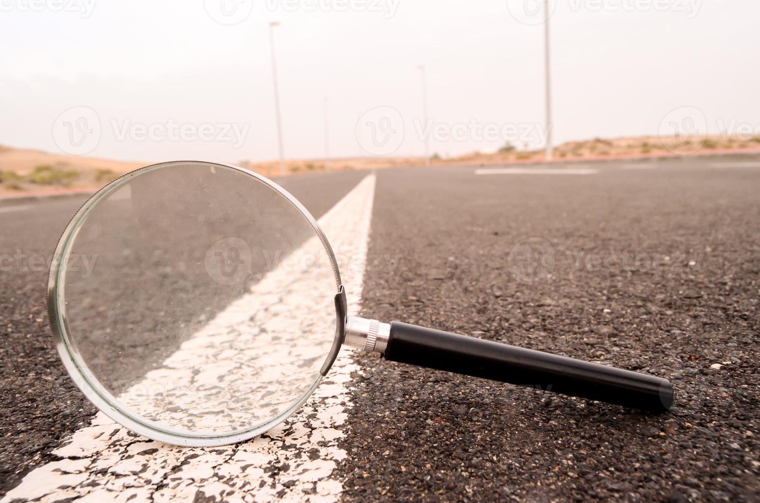 Magnifying glass on the road photo