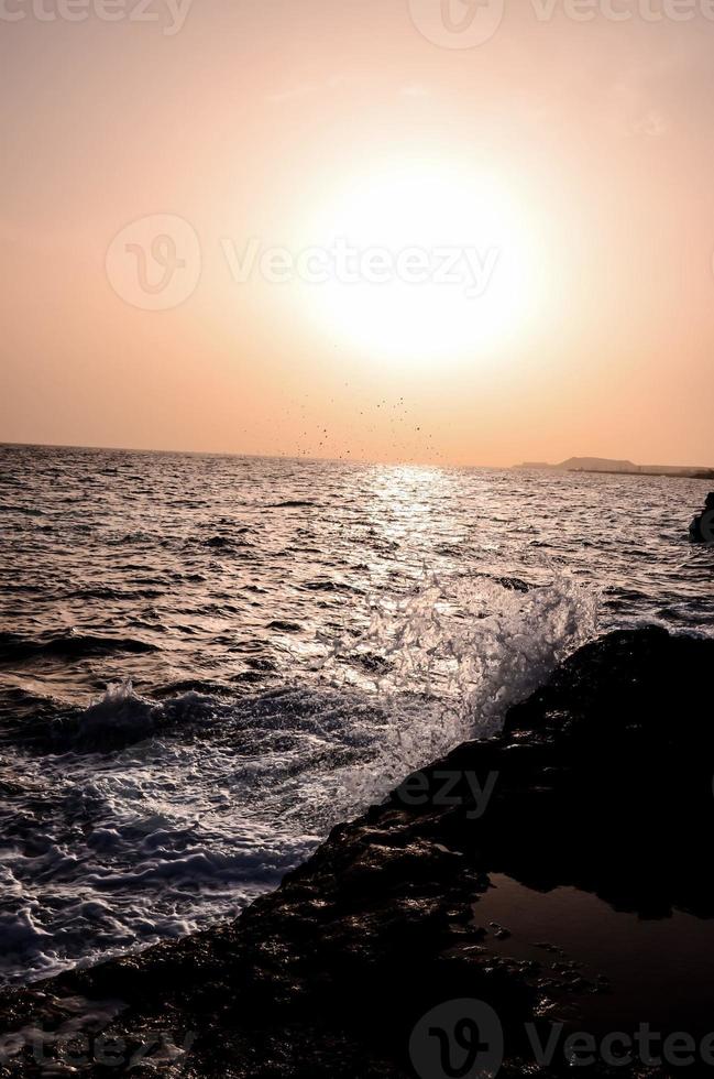 Sea waves hitting rocks photo