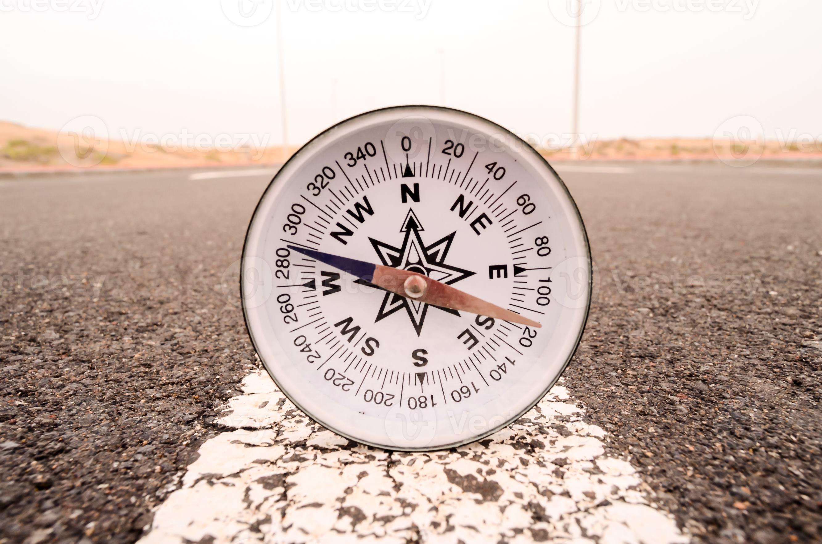 Analog compass on the road 17478238 Stock Photo at Vecteezy