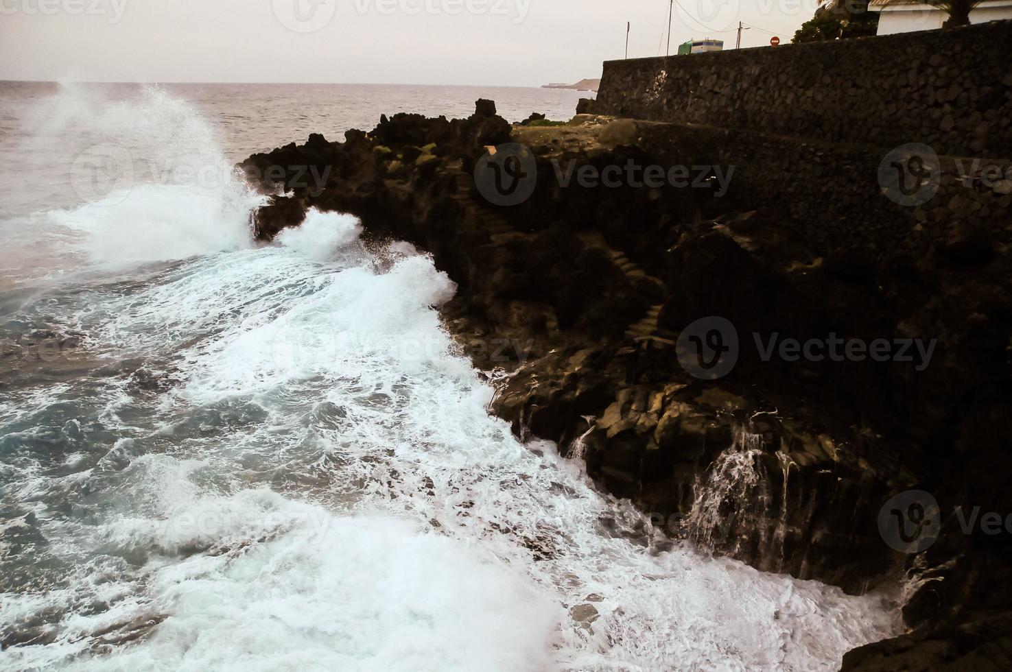 Waves hitting rocks photo