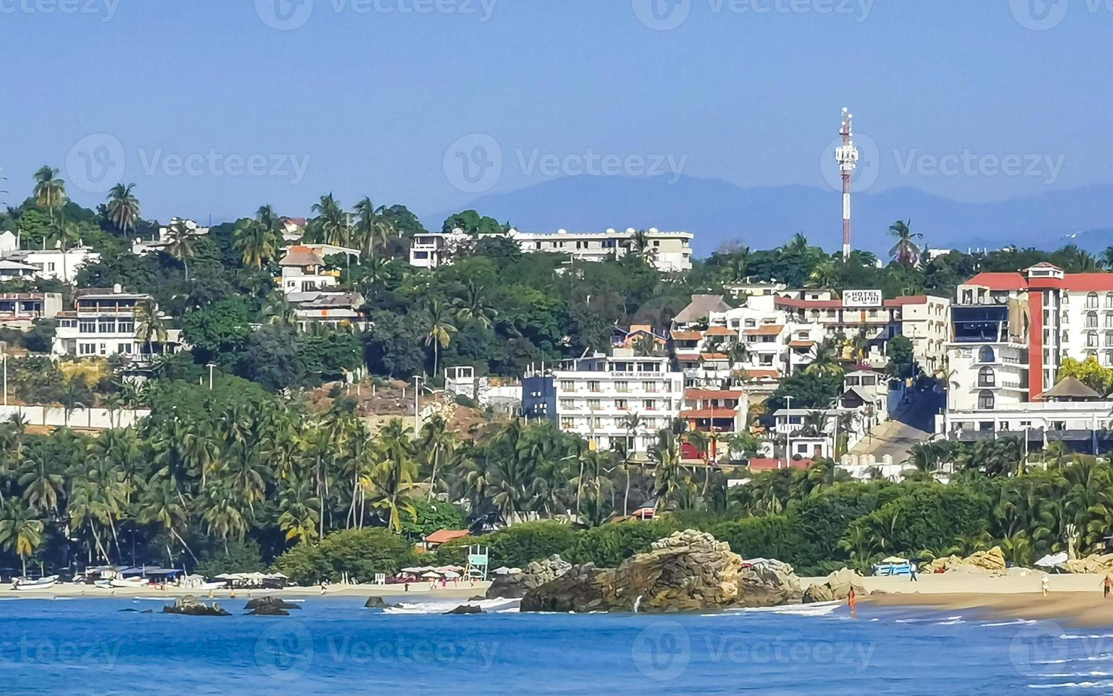 Sun beach people waves and boats in Puerto Escondido Mexico. photo