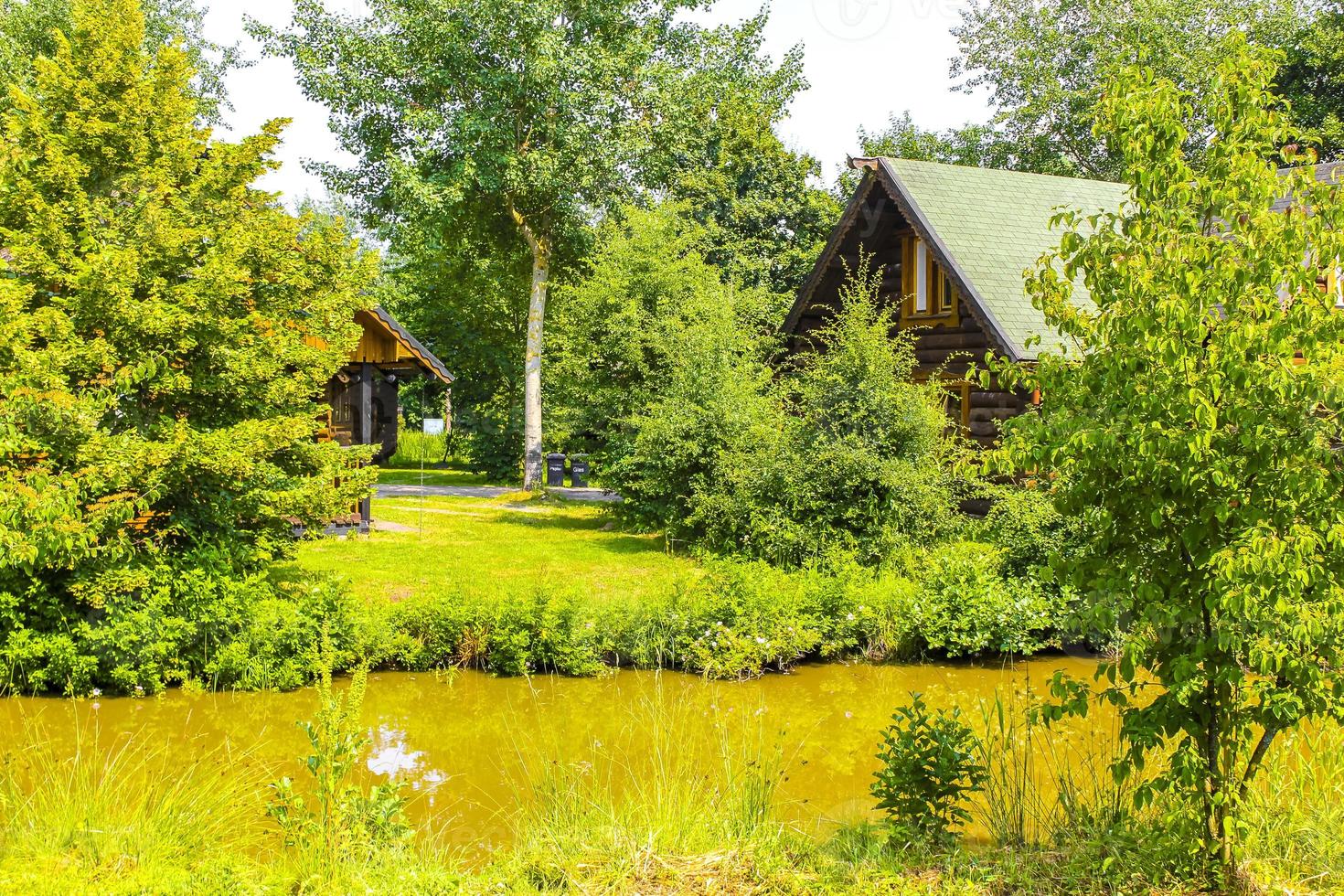 Vacation home wooden house in forest by lake river Germany. photo