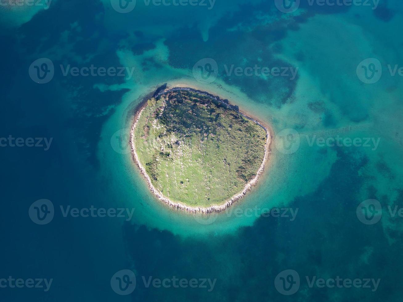 Aerial drone view of a small Island in Croatia with beautiful blue turquoise sea water. Travel and holidays destination. Amazing tourism in Croatia Islands. Black space for copy paste. Wallpaper. photo