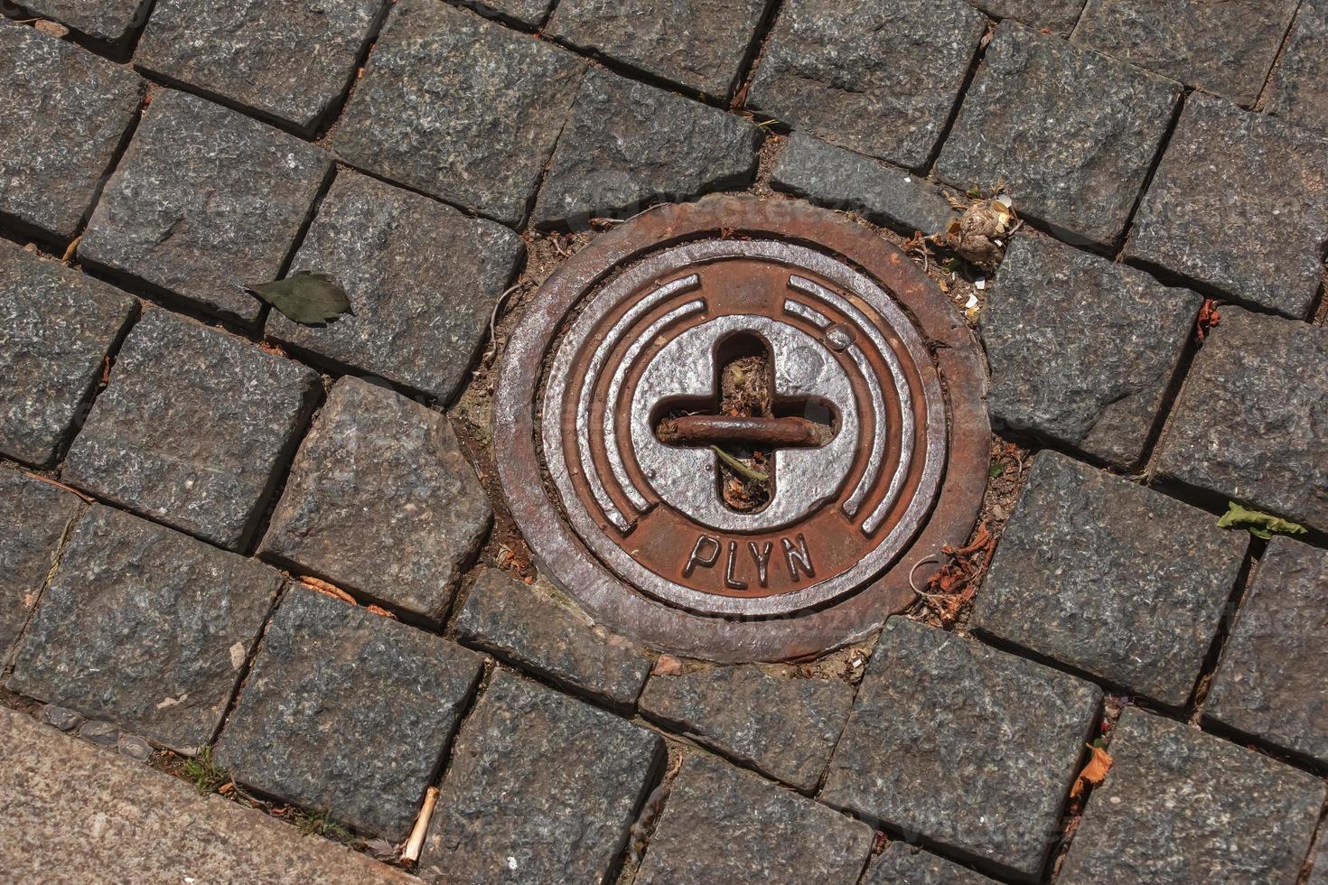 Manhole cover of the gas pipeline system. A massive metal hatch for access to city communications in the pavement. photo