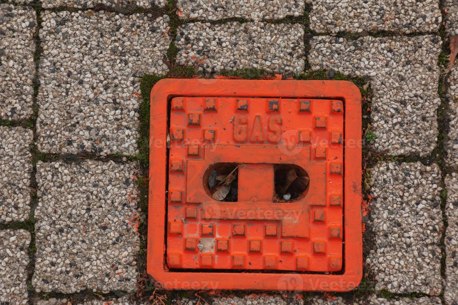 Manhole cover of the gas pipeline system. A massive metal hatch for access to city communications in the pavement. photo