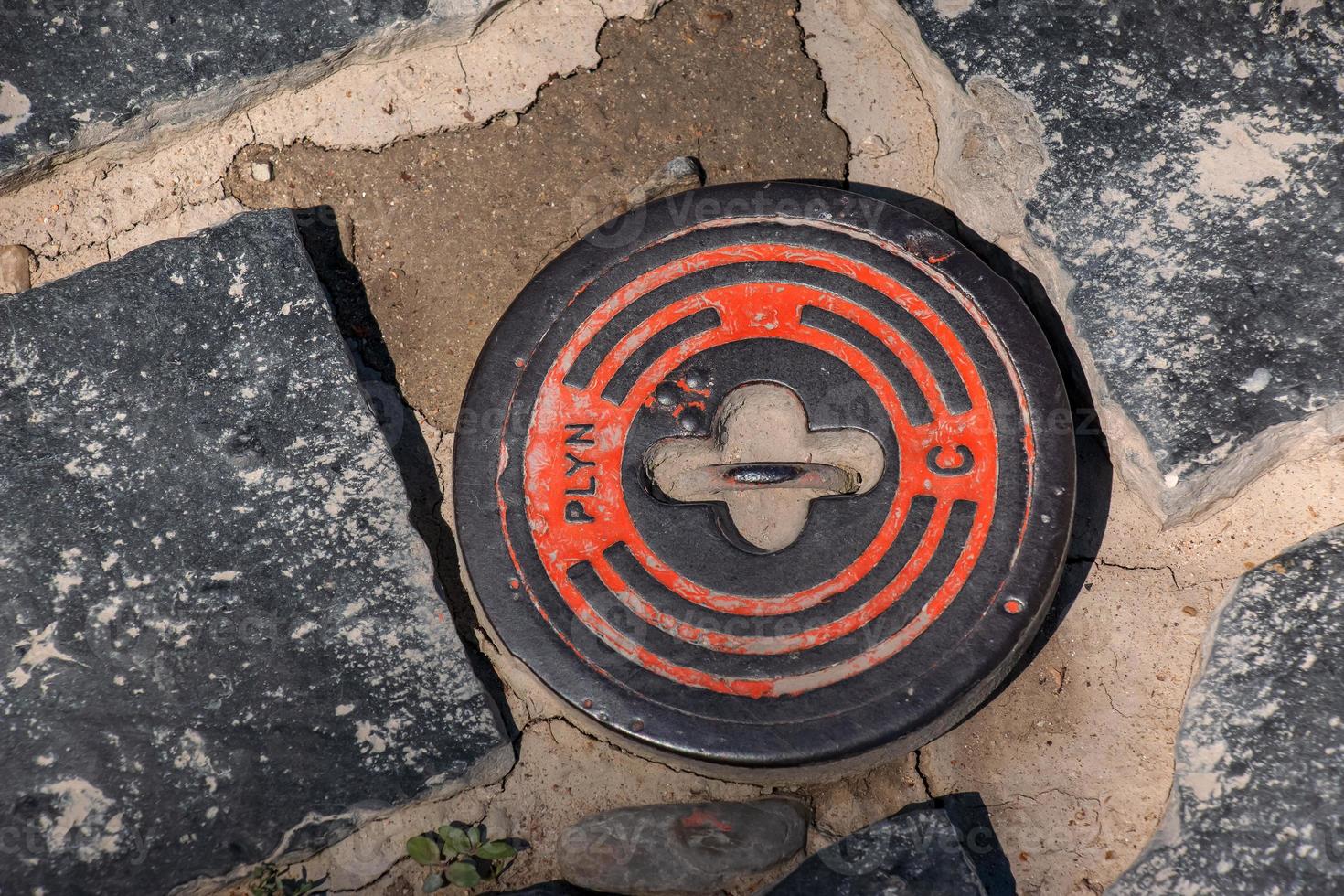 Manhole cover of the gas pipeline system. A massive metal hatch for access to city communications in the pavement. photo