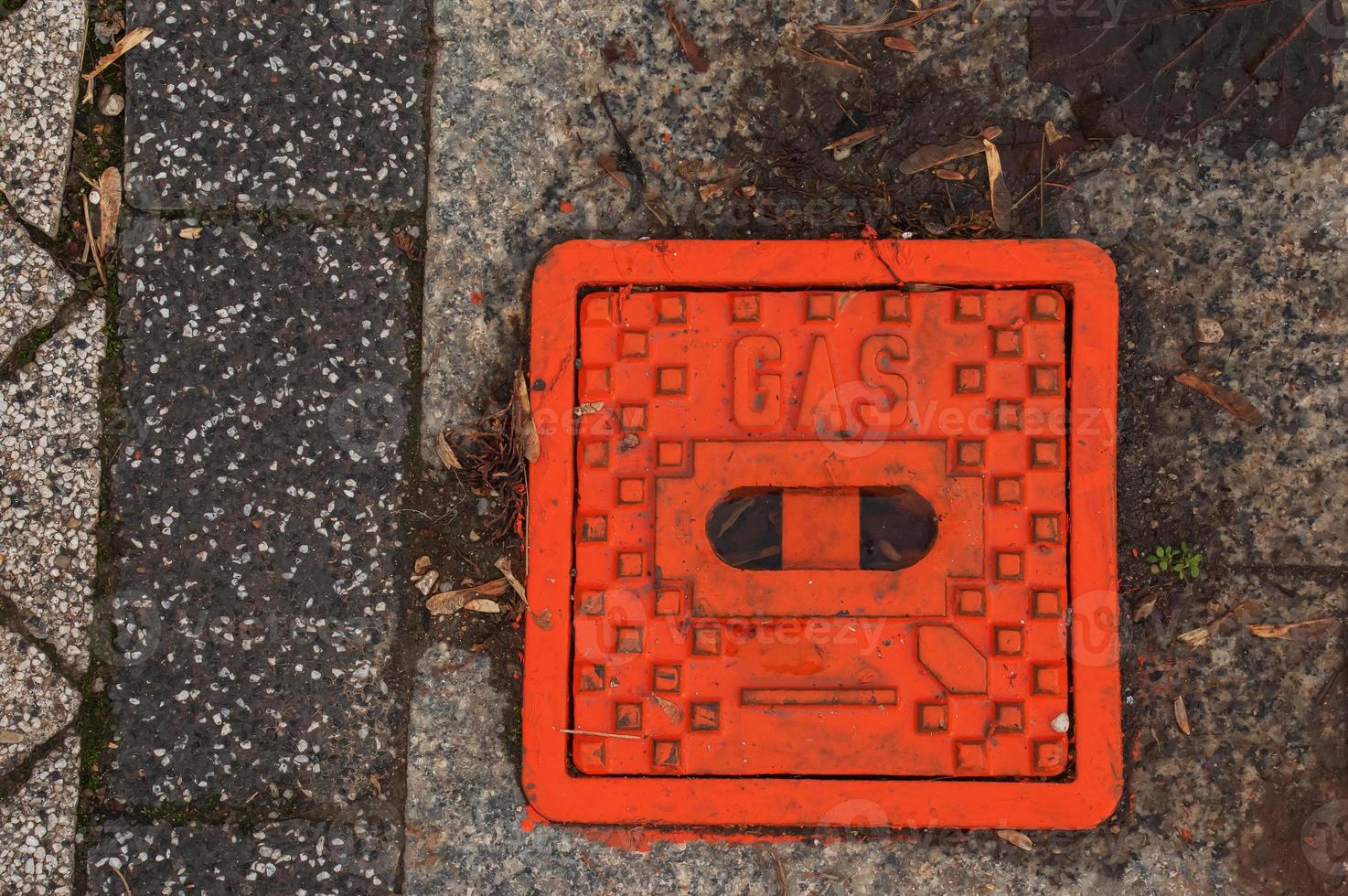 Manhole cover of the gas pipeline system. A massive metal hatch for access to city communications in the pavement. photo