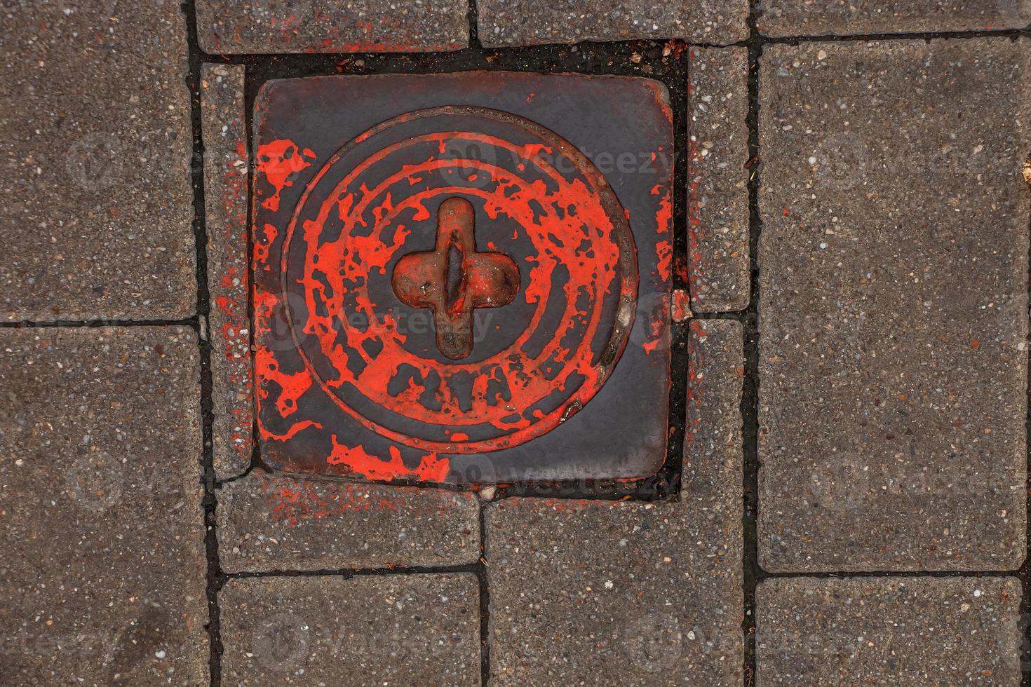 Manhole cover of the gas pipeline system. A massive metal hatch for access to city communications in the pavement. photo