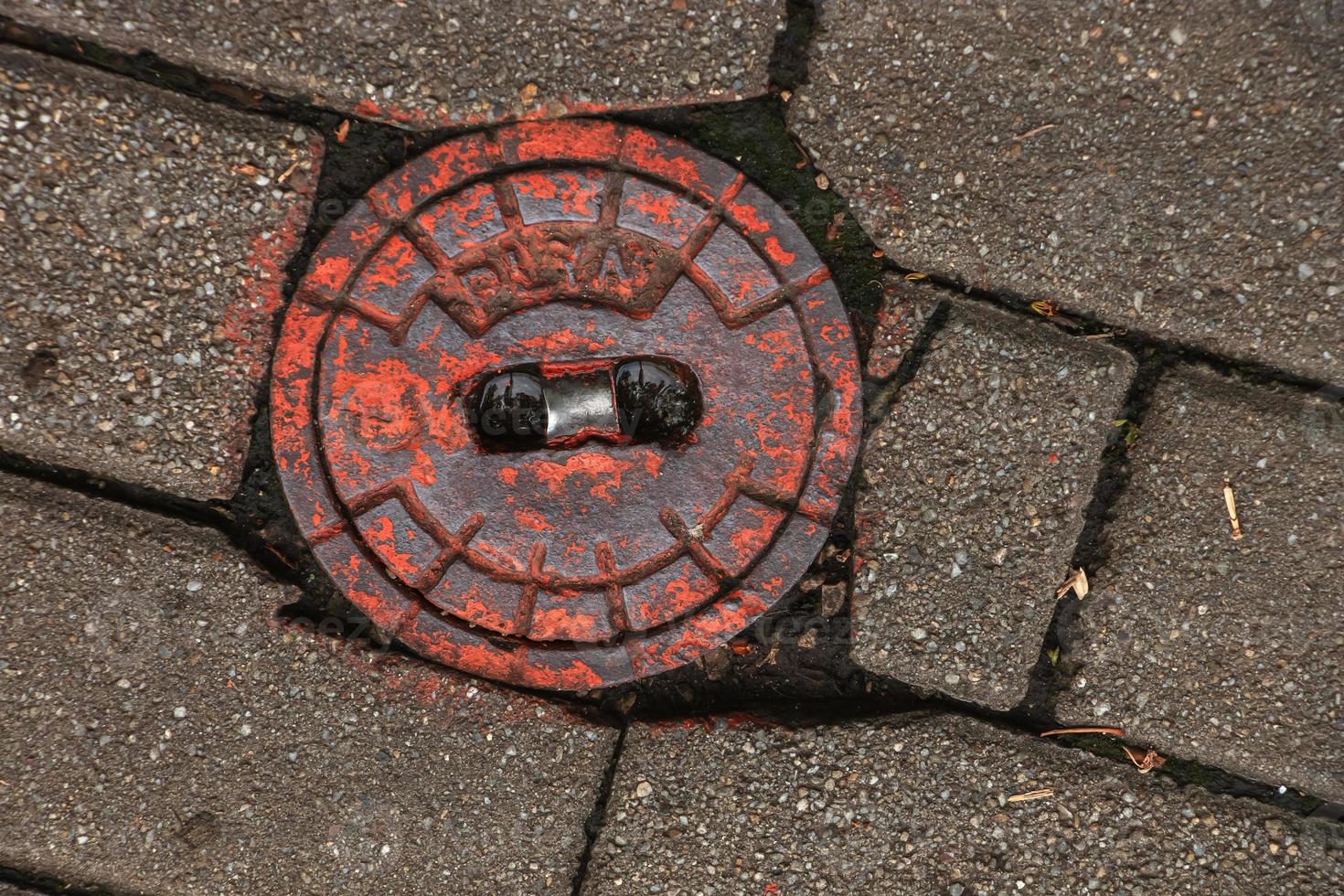 Manhole cover of the gas pipeline system. A massive metal hatch for access to city communications in the pavement. photo