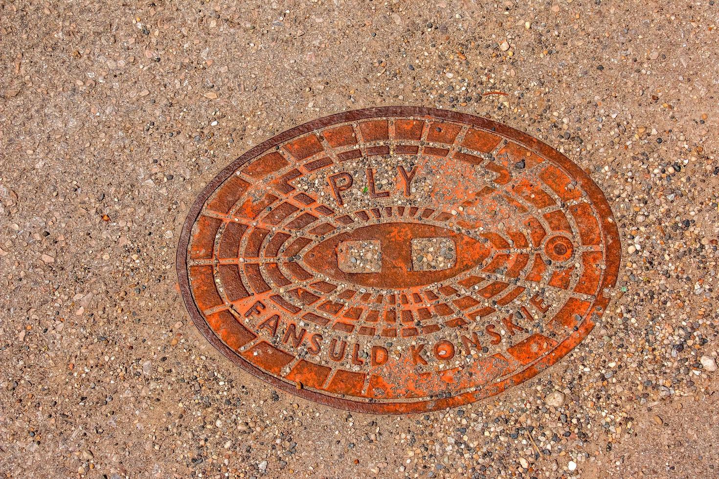 Manhole cover of the gas pipeline system. A massive metal hatch for access to city communications in the pavement. photo