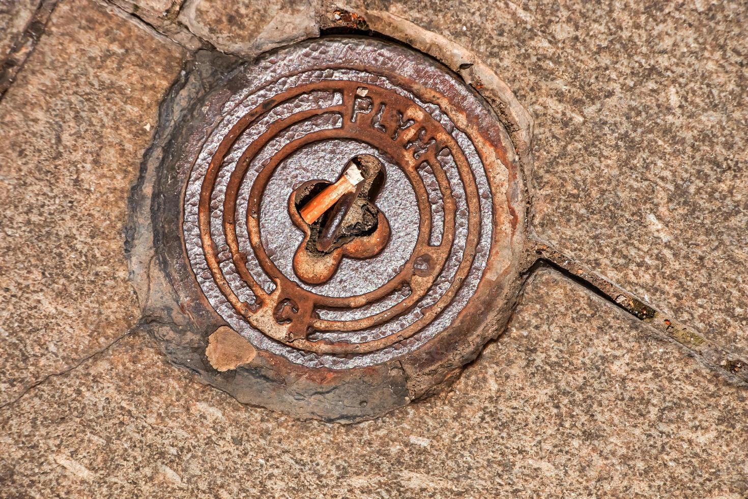 Manhole cover of the gas pipeline system. A massive metal hatch for access to city communications in the pavement. photo