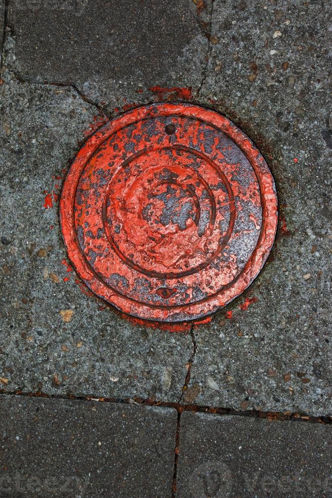 tapa de alcantarilla del sistema de gasoductos. una escotilla metálica masiva para el acceso a las comunicaciones de la ciudad en el pavimento. foto