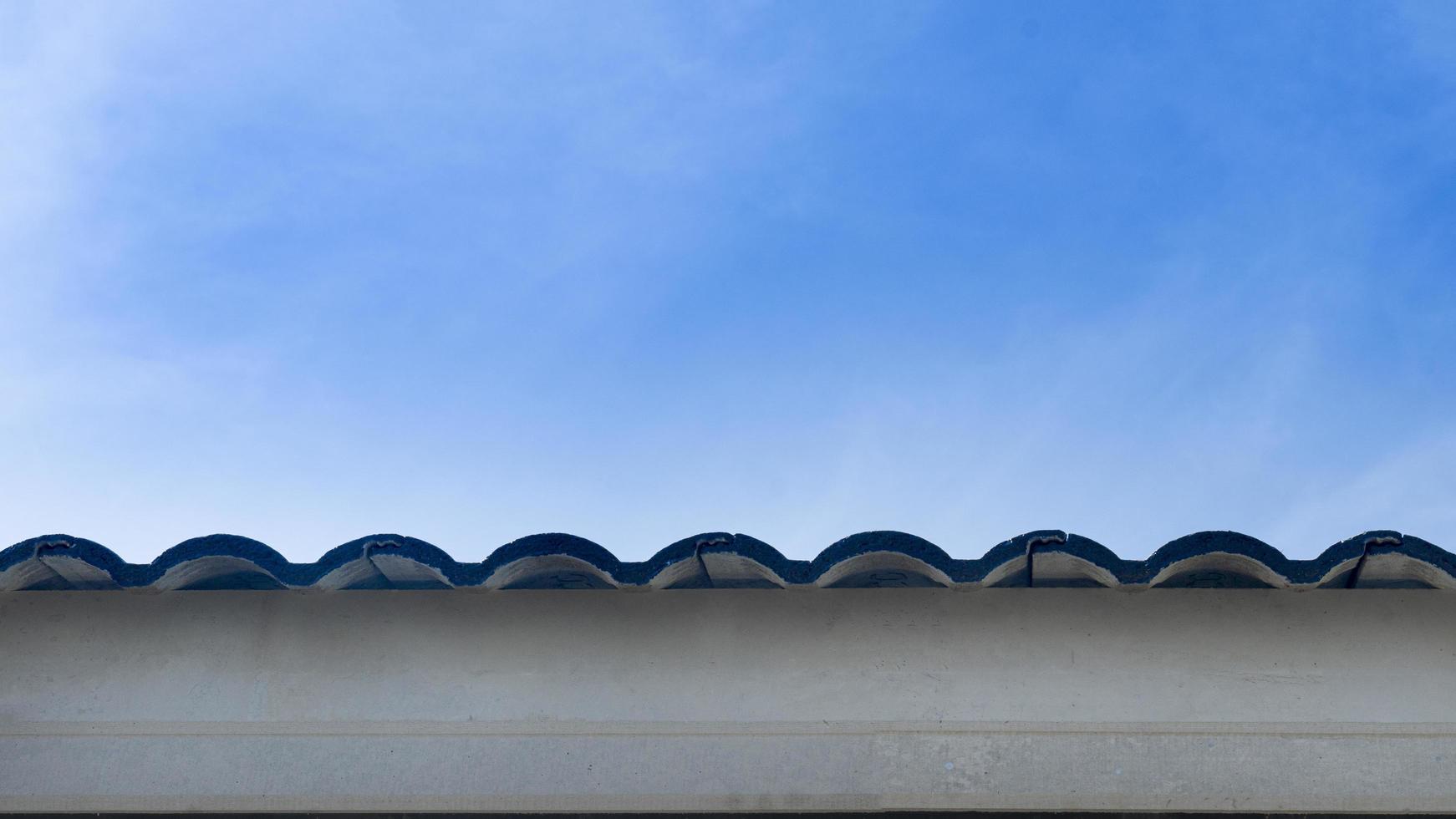 Abstract of roof eaves with wooden slats covering the bottom. Under the blue sky. Free space for insert text. photo