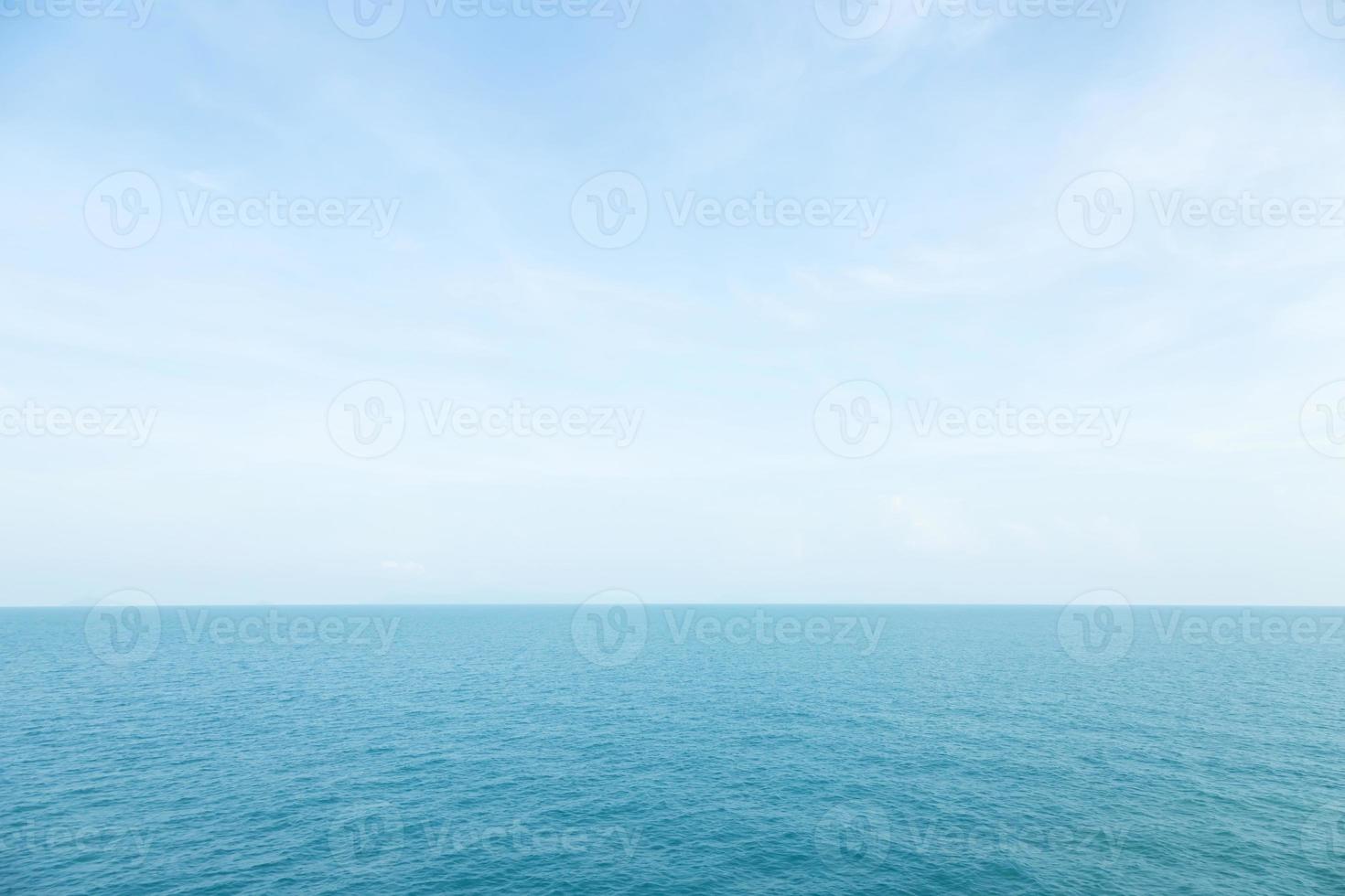 Sea waves in ocean wave splashing thinly ripple water. Blue water and sky background. photo